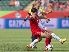 In this June 11, 2015, file photo, China's Han Peng (18) and Netherlands Stefanie van der Gragt battle for the ball during the second half of a FIFA Women's World Cup soccer game in Edmonton. The use of artificial turf at the tournament in Canada had been a contentious issue with the players.