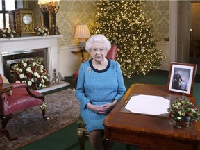 In this photo released early Sunday Dec. 25, 2016, Britain's Queen Elizabeth II poses for a photo, sitting at a desk in the Regency Room of Buckingham Palace in London, after recording her traditional Christmas Day broadcast to the Commonwealth.