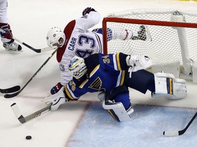 St. Louis Blues goalie Jake Allen (34) and Montreal Canadiens' Daniel Carr (43) reach for a loose puck during the second period of an NHL hockey game, Tuesday, Dec. 6, 2016, in St. Louis.