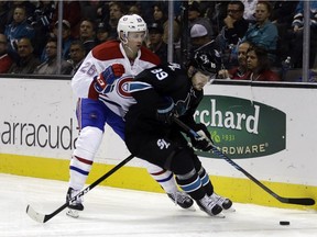 Montreal Canadiens' Jeff Petry, left, and San Jose Sharks' Mikkel Boedker (89) fight for the puck during the third period of an NHL hockey game Friday, Dec. 2, 2016, in San Jose, Calif. The Sharks won 2-1.