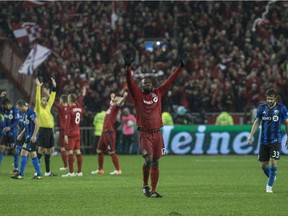 Toronto FC forward Jozy Altidore (centre) celebrates as the referee blows the final whistle as his team defeats the Montreal Impact during overtime MLS eastern conference playoff soccer final action in Toronto on Wednesday, November 30, 2016.