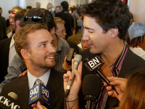 Alexandre (Sasha) & Justin Trudeau (L-R) speak to the media after a press conference on Sept. 9, 2003 about the renaming of Dorval Airport to Pierre Elliott Trudeau International Airport
