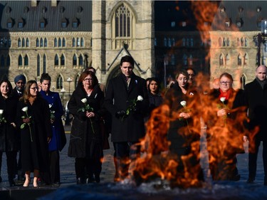 Prime Minister Justin Trudeau and members of cabinet lay flowers on Parliament Hill in Ottawa on Tuesday, Dec. 6, 2016, in remembrance of the victims of the Ecole Polytechnique de Montreal massacre.