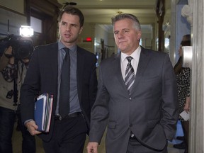 Quebec Transport Minister Laurent Lessard, right, leaves a party caucus meeting with press attache Mathieu Gaudreault, left, Tuesday, December 6, 2016 at the legislature in Quebec City.