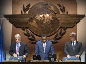 Transport Minister Marc Garneau, ICAO president Olumuyiwa Benard Aliu, and Quebec Premier Philippe Couillard, left to right, take their seat for the opening session of the 39th assembly of UN aviation agency, Tuesday, September 27, 2016 in Montreal.