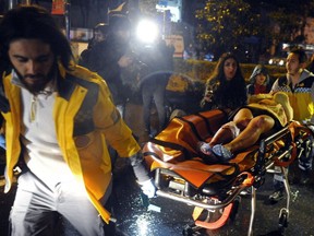 Medics carry a wounded person at the scene after an attack at a popular nightclub in Istanbul, early Sunday, Jan. 1, 2017. Istanbul Governor Vasip Sahin said that an armed assailant has opened fire at a nightclub in Istanbul during New Year's celebrations. Turkish authorities have banned distribution of images relating to the Istanbul attack within Turkey.