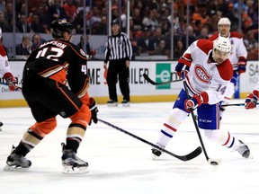 Tomas Plekanec of the Montreal Canadiens shoots the puck as Josh Manson of the Anaheim Ducks defends during the second period of a game at Honda Center on November 29, 2016 in Anaheim, California.
