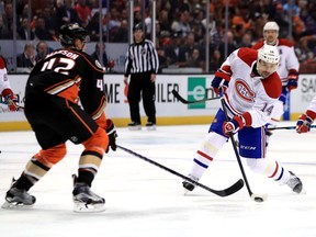 Tomas Plekanec of the Montreal Canadiens shoots as Josh Manson of the Anaheim Ducks defends during the second period of a game at Honda Center on November 29, 2016, in Anaheim, California.