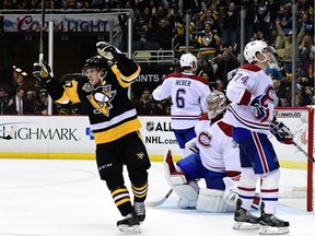 Sidney Crosby of the Pittsburgh Penguins celebrates an overtime goal scored by Evgeni Malkin against the Canadiens on Saturday, Dec. 31, 2016 in Pittsburgh.