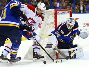Jake Allen #34 of the St. Louis Blues looks to make a save against Tomas Plekanec #14 of the Montreal Canadiens at the Scottrade Center on December 6, 2016 in St. Louis, Missouri.