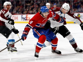 Montreal Canadiens left wing Phillip Danault and Colorado Avalanche left wing Blake Comeau race to the corner during NHL action at the Bell Centre in Montreal on Saturday, Dec. 10, 2016. Colorado Avalanche defenseman François Beauchemin, left, looks on.