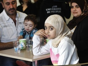 Bassam Alamir and his wife Faten Nseirat with two of their four children: Maria, 8, and Zaid, 1. The family arrived from Syria Jan. 15 and now live in Granby.