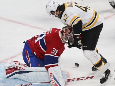 Boston Bruins' David Backes (42) puts his gloves and stick in the face of Montreal Canadiens goalie Carey Price during second period NHL action in Montreal on Monday December 12, 2016.