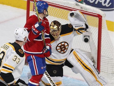 Boston Bruins goalie Tuukka Rask stops puck in his glove in front of Montreal Canadiens' Andrew Shaw while Zdeno Chara (33) comes in on the play, during second period NHL action in Montreal on Monday December 12, 2016.