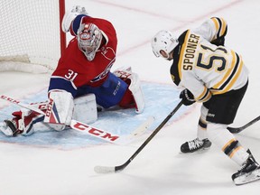 Boston Bruins' Ryan Spooner sends puck past the legs of Montreal Canadiens goalie Carey Price into the net for winning goal in overtime period NHL action in Montreal on Monday December 12, 2016.