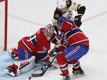 Montreal Canadiens goalie Carey Price and  Shea Weber (6) move puck away from Boston Bruins' David Backes (42) during second period NHL action in Montreal on Monday December 12, 2016.