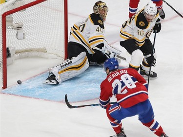 Montreal Canadiens' Nathan Beaulieu (28) lets go of shot that misses net, while Boston Bruins goalie Tuukka Rask  and Kevan Miller (86) try to catch up on the play, during first period NHL action in Montreal on Monday December 12, 2016.