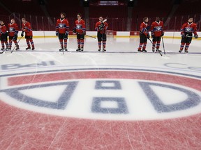 Members of the Under Armour Red team stand at centre ice for the national anthem, prior to their game against the Under Armour White team at the Bell Centre on Tuesday December 13, 2016.