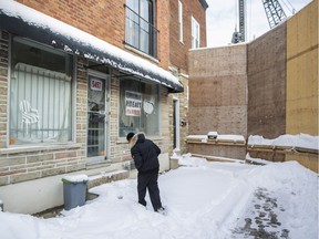 Upholsterer Frank Berdah outside his store on St-Jacques St. W., which faces a large sound barrier erected nearly two years ago during construction, on Tuesday, December 13, 2016. Berdah says the wall has cost him clients and now his business is struggling.