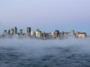 Ice fog rises off the St. Lawrence River as dawn breaks over downtown Montreal, Friday Dec. 16, 2016.