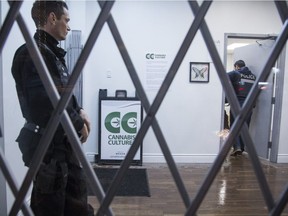 Police inside a Cannabis Culture store after a raid at the Mont-Royal Ave. location in Montreal, Friday December 16, 2016.