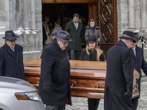 Family of former federal minster Warren Allmand follow pallbearers carrying his casket at the end of his funeral at St. Patrick's Basilica in Montreal on Monday, December 19, 2016.