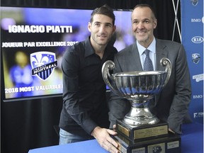 Impact president Joey Saputo presents the most valuable player trophy to Ignacio Piatti at an end-of-the-season press conference at Centre Nutrilait in Montreal on Friday, Dec. 2, 2016.