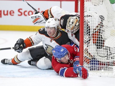 Montreal Canadiens Artturi Lehkonen crashes into Anaheim Ducks goalie Jonathan Bernier and defenceman Dampus Lindholm, left, during first period of National Hockey League game in Montreal Tuesday Dec. 20, 2016.