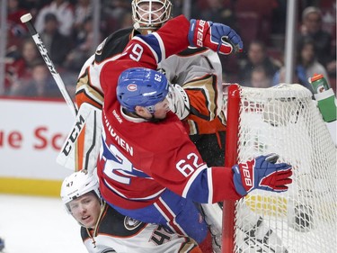 Montreal Canadiens Artturi Lehkonen crashes into Anaheim Ducks defenceman Hampus Lindholm, left, and goalie Jonathan Bernier during first period of National Hockey League game in Montreal Tuesday Dec. 20, 2016.
