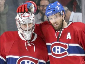 Canadiens' Carey Price gets a pat on the head from teammate Shea Weber on Tuesday. Weber has 8-10-18 totals in 32 games and his plus-18 was the third-best plus/minus figure in the NHL through Tuesday's games.