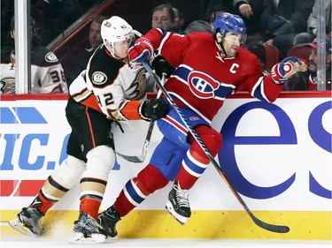 Montreal Canadiens Max Pacioretty skates through check by Anaheim Ducks Josh Manson during first period of National Hockey League game in Montreal Tuesday Dec. 20, 2016.