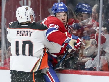 Montreal Canadiens Nathan Beaulieu is checked into the glass by Anaheim Ducks Corey Perry during second period of National Hockey League game in Montreal Tuesday Dec. 20, 2016.