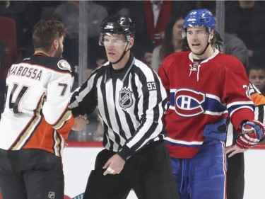 Montreal Canadiens Nathan Beaulieu has words with Anaheim Ducks Joseph Cramarossa at the end of the second period of National Hockey League game in Montreal Tuesday Dec. 20, 2016, after Cramarossa was involved in a scuffle with Habs Torrey Mitchell.