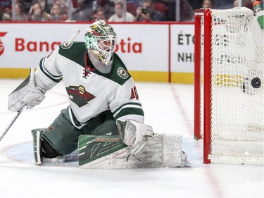 Minnesota Wild goalie Devan Dubnyk keeps his eye on a wide shot during first period of National Hockey League game against the Montreal Canadiens in Montreal Thursday Dec. 22, 2016.