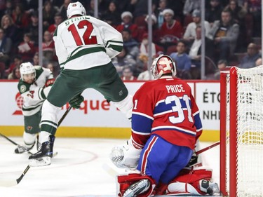 Minnesota Wild's Eric Staal jumps in front of Montreal Canadiens Carey Price as Wild teammate Matt Dumba takes a shot during second period of National Hockey League game in Montreal Thursday Dec. 22, 2016.