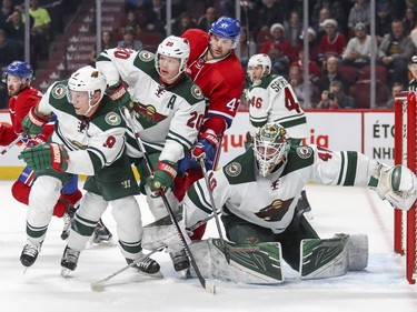 Minnesota Wild's Mikko Koivu, left, and Ryan Suter provide support to goalie Devan Dubnyk as Montreal Canadiens Alexander Radulov fights for position during third period of National Hockey League game in Montreal Thursday Dec. 22, 2016. Habs Paul Byron and Wild's Jared Spurgeon trail the play.