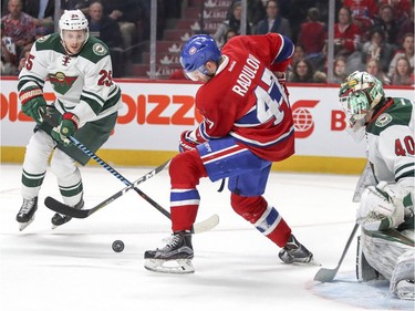 Montreal Canadiens Alexander Radulov has trouble controlling loose puck in front of Minnesota Wild goalie Devan Dubnyk and defenceman Jonal Brodin  during first period of National Hockey League game in Montreal Thursday Dec. 22, 2016.