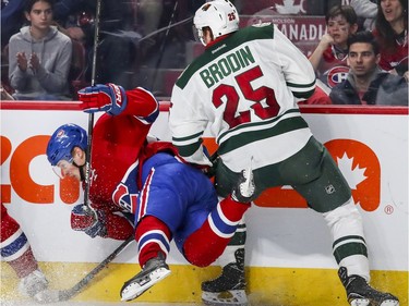 Montreal Canadiens Artturi Lehkonen is checked to the ice by Minnesota Wild's Jonas Brodin during third period of National Hockey League game in Montreal Thursday Dec. 22, 2016.