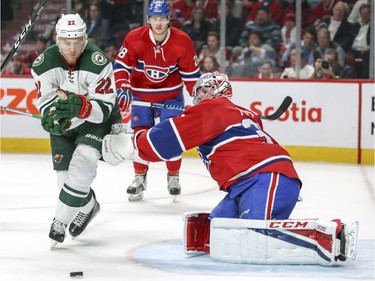 Montreal Canadiens Carey Price reaches out to slow down Minnesota Wild's Nino Niederreiter during second period of National Hockey League game in Montreal Thursday Dec. 22, 2016.