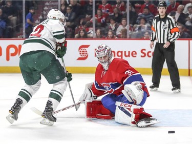 Montreal Canadiens Carey Price kicks the puck away from Minnesota Wild's Nino Niederreiter during second period of National Hockey League game in Montreal Thursday Dec. 22, 2016.