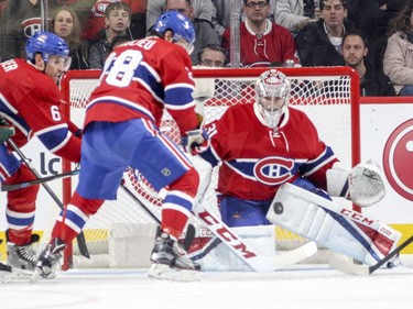 Montreal Canadiens goalie Carey Price and defencemen Shea Weber, left, and Nathan Beaulieu keep an eye on a shot during a Minnesota Wild power play during the first period of National Hockey League game in Montreal Thursday Dec. 22, 2016.
