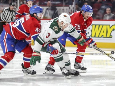 Montreal Canadiens Mark Barberio, left, and Jeff Petry team up to knock the puck away from Minnesota Wild's Charlie Coyle during second period of National Hockey League game in Montreal Thursday Dec. 22, 2016.