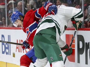 Montreal Canadiens Phillip Danault fights for the puck with Minnesota Wild's Ryan Suter, right, during first period of National Hockey League game in Montreal Thursday Dec. 22, 2016.