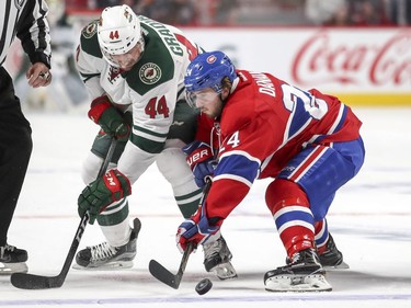 Montreal Canadiens Phillip Danault wins a face-off against Minnesota Wild's Tyler Graovac during second period of National Hockey League game in Montreal Thursday Dec. 22, 2016.