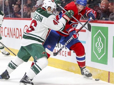 Montreal Canadiens Torrey Mitchell is cross-checked by Minnesota Wild's Jared Spurgeon during third period of National Hockey League game in Montreal Thursday Dec. 22, 2016.