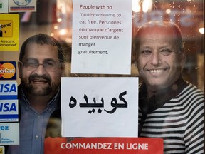 Yahya Hashemi, left, and Ala Amiry are trying to help feed some of the poor and hungry in their neighbourhood. Hashemi runs the Elite Forex currency exchange and Amiry owns Marché Ferdous. The pair are seen at the restaurant in Montreal on Friday December 23, 2016.