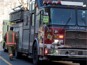 MONTREAL, QUE.: DECEMBER 30, 2014-- Montreal firemen from Station 5 respond to a person in distress call in Montreal on Tuesday December 30, 2014. Station 5 is Canada's busiest fire stations and the firemen were needed to help paramedics load the patient into a waiting ambulance. (Allen McInnis / MONTREAL GAZETTE)