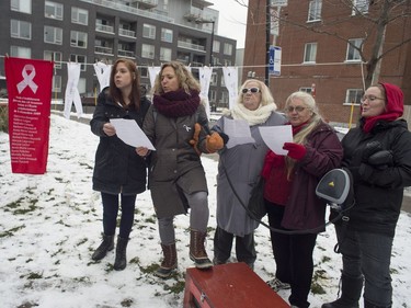 Woman sing a hymn during a ceremony  held by the campaign, 12 days of action against violence against women, to commemorate the victims of the Montreal massacre in a city park beside the Bain Mathieu on Ontario St. East. in Montreal on Tuesday, December 6, 2016.