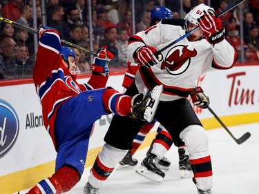 Montreal Canadiens centre Andrew Shaw gets knocked to the ice by New Jersey Devils centre Sergey Kalinin during NHL action at the Bell Centre in Montreal on Thursday December 8, 2016.