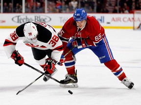 Montreal Canadiens centre Andrew Shaw and New Jersey Devils left wing Vernon Fiddler battle for the puck during NHL action at the Bell centre in Montreal on Thursday December 8, 2016.